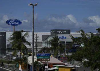 Signs are displayed for dealerships for BYD and Ford in Camacari, Bahia state, Brazil, Friday, March 7, 2025